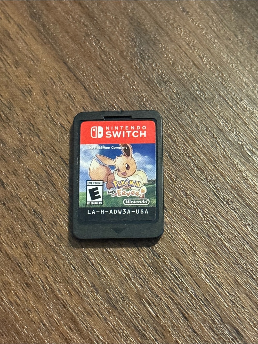 Nintendo Switch game card with red and black label featuring Eevee